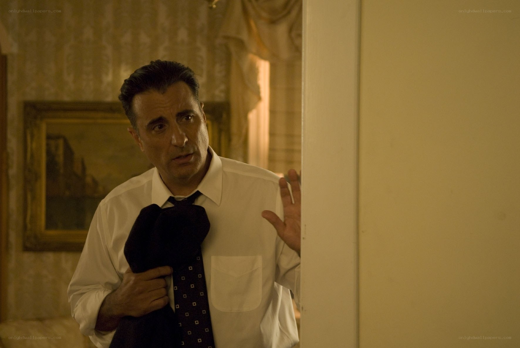 man holding tie in hallway