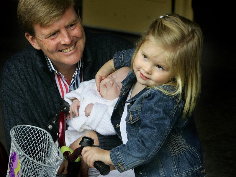 Man Holding Two Children