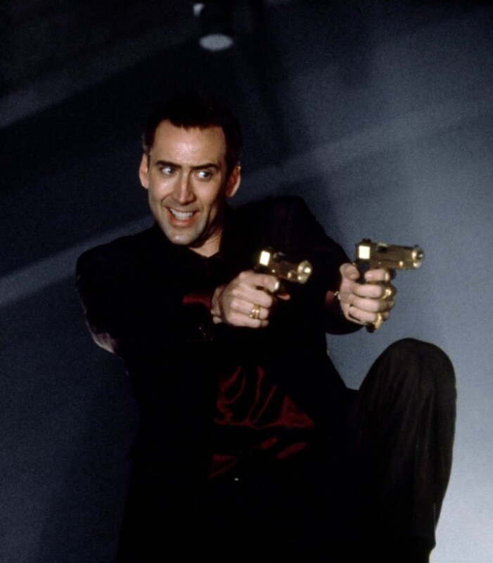 Man holding two golden guns