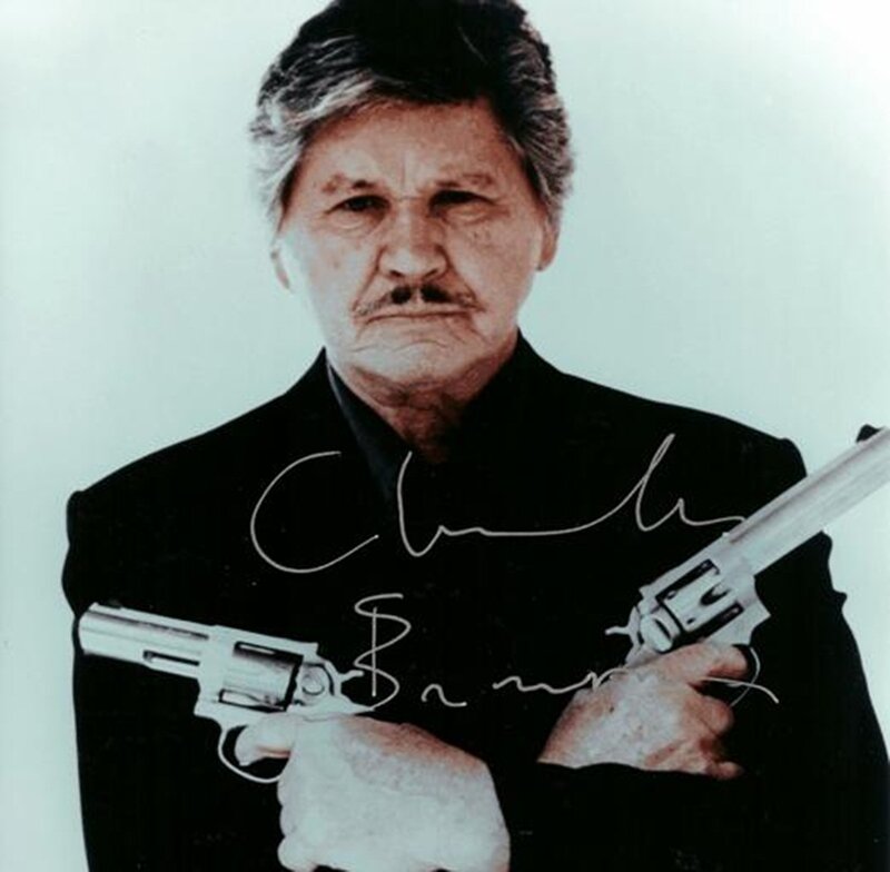 Man Holding Two Guns — Black, Serious