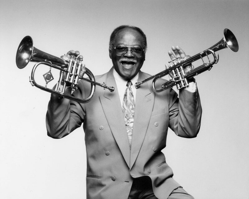 Man holding two trumpets