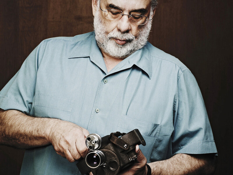 man holding vintage camera