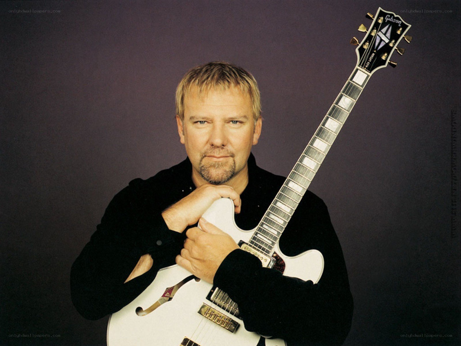 man holding white electric guitar