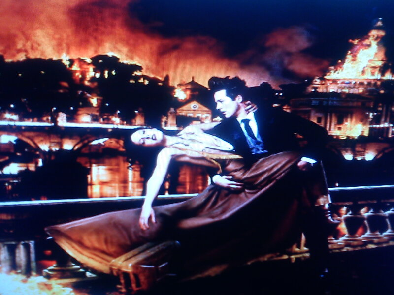 Man Holding Woman on Bridge