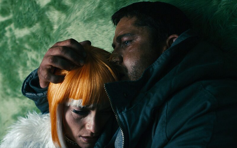 Man holding woman's head