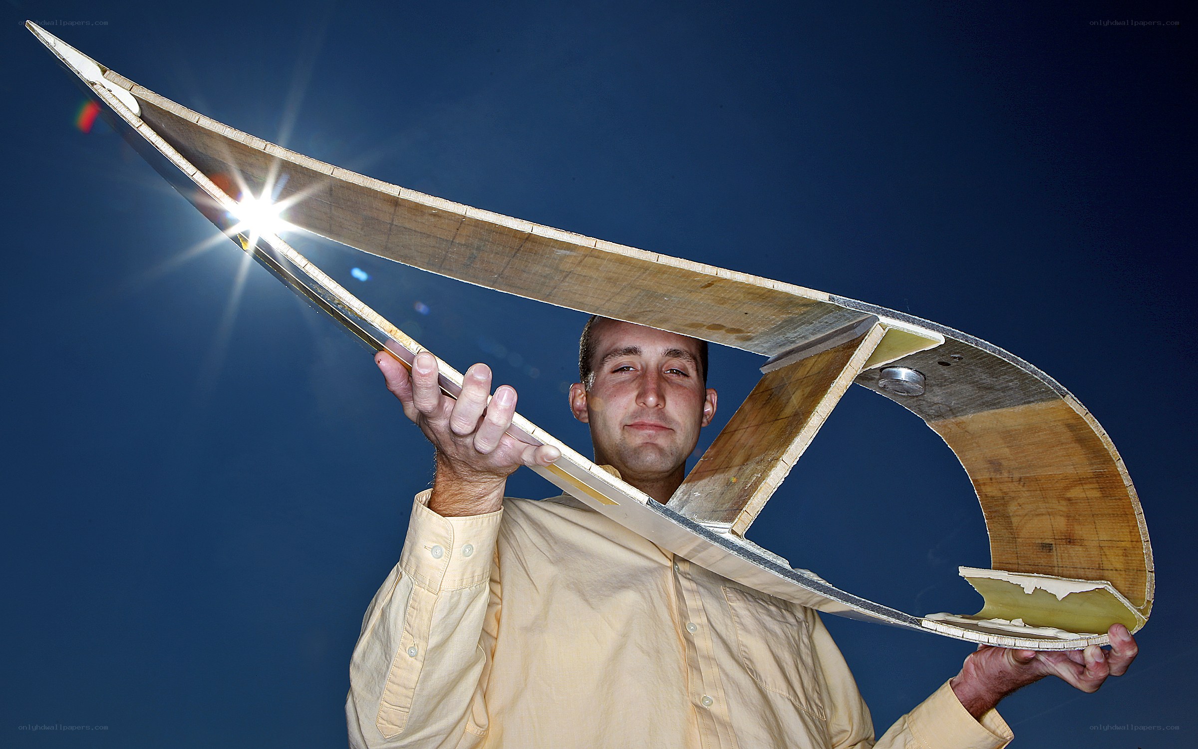 Man holding wooden glider