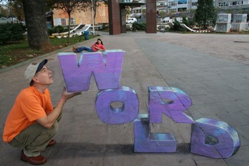 Man Holding World Letters
