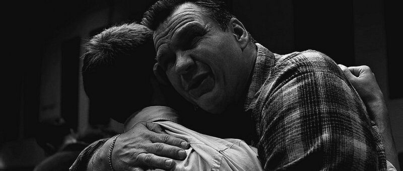 Man Hugging Another Man — Black, Dramatic