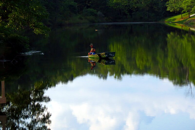 Man in a Boat — Green, Serene, Sunset