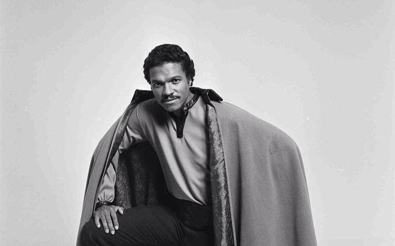 Man in a cape posing