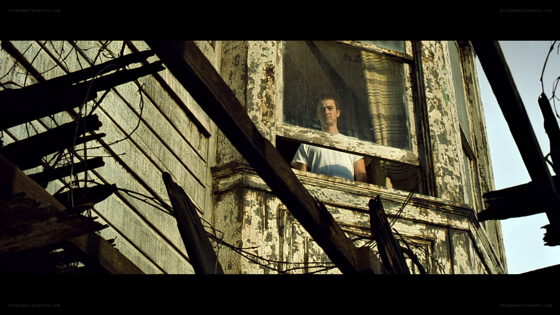 man in a dilapidated house