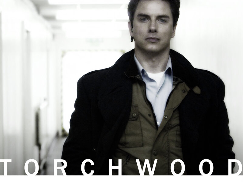 Man in a hallway with Torchwood text