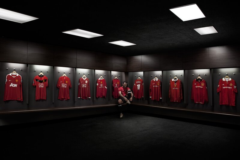 Man in a locker room with jerseys