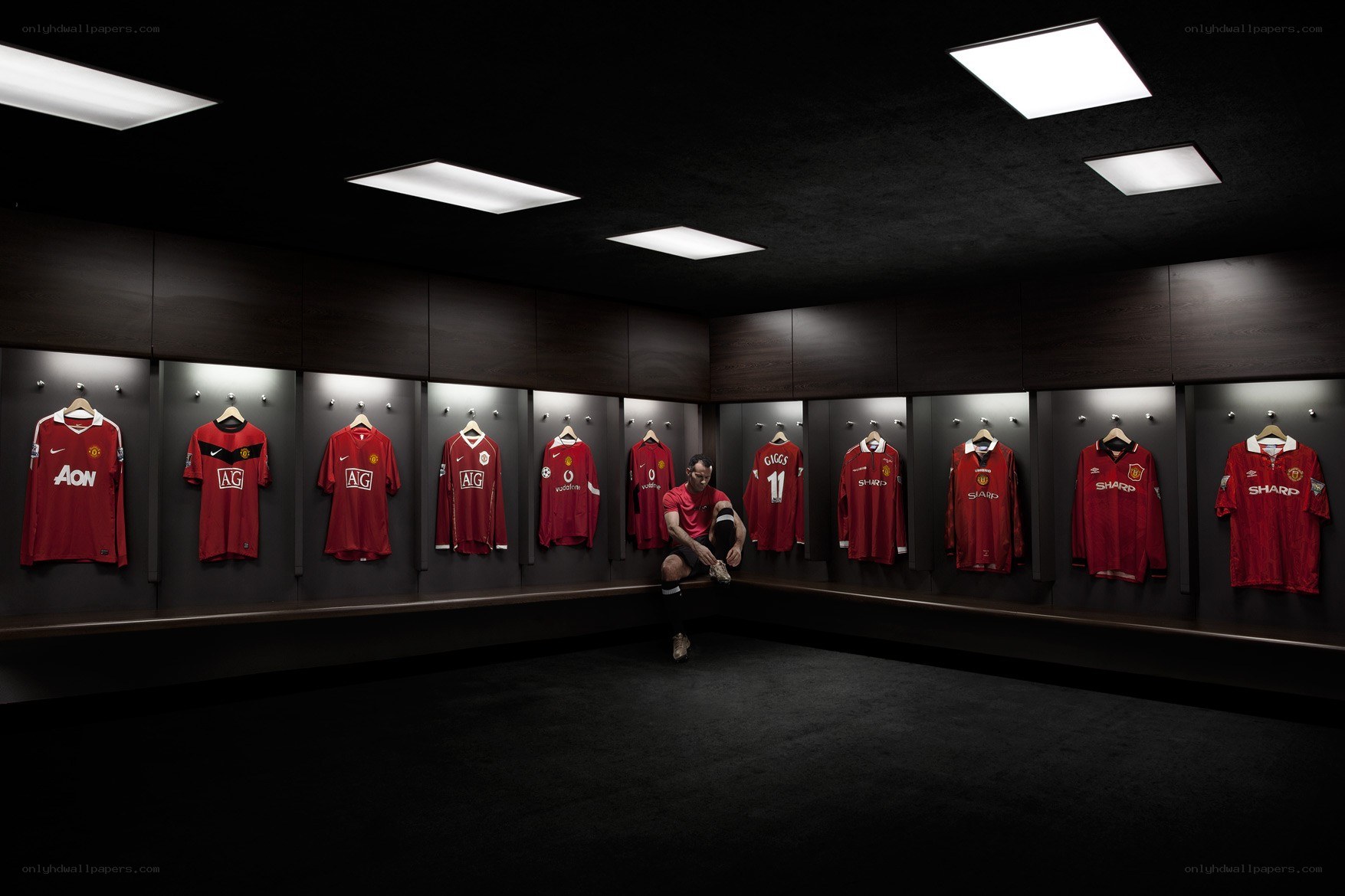 Man in a locker room with jerseys