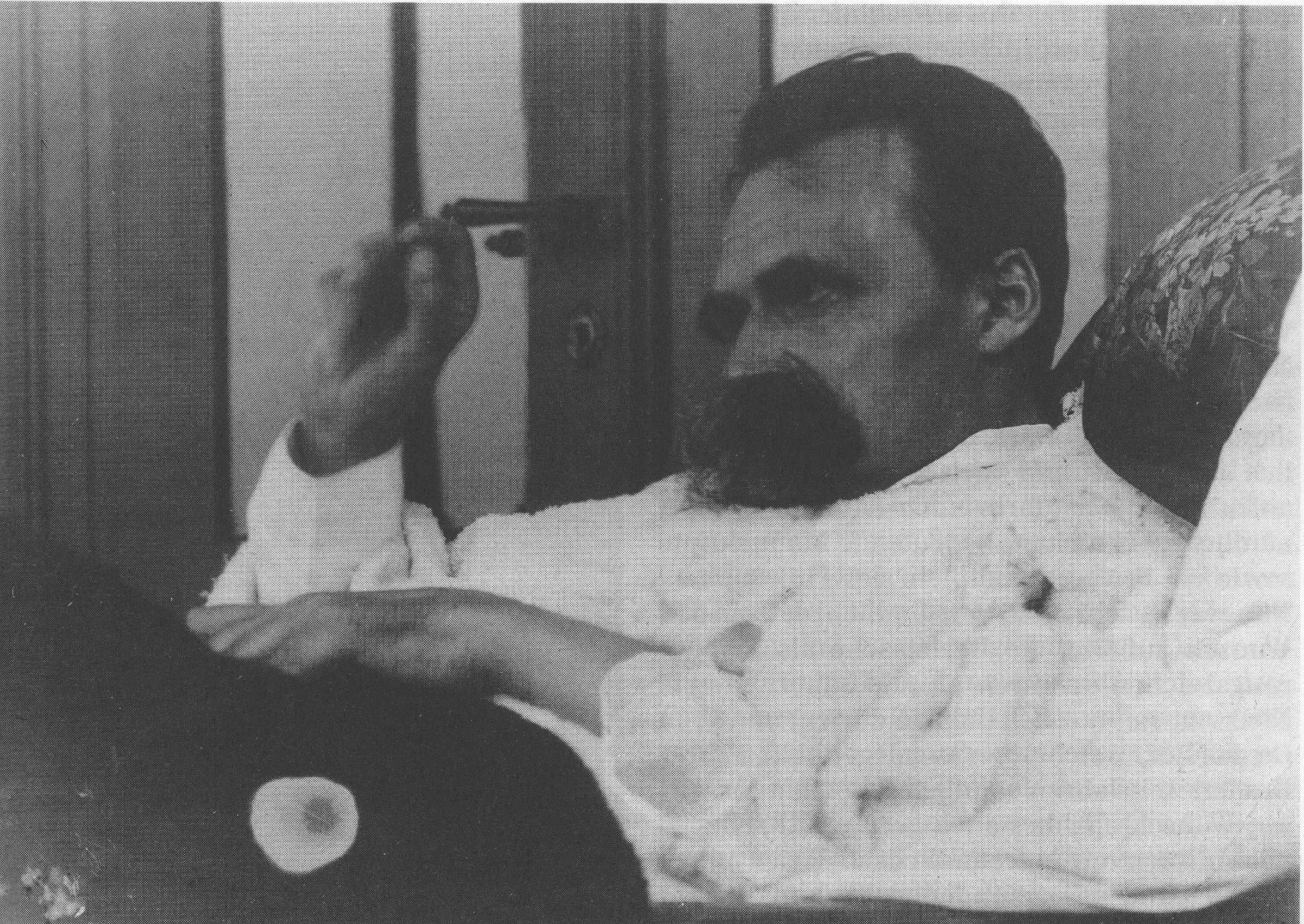 Man in a robe holding a pipe