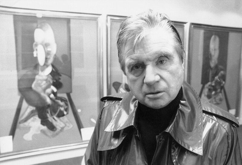 Man in a shiny jacket at an art gallery