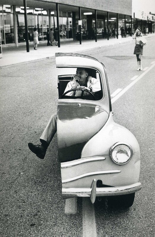 Man in a small car on the street