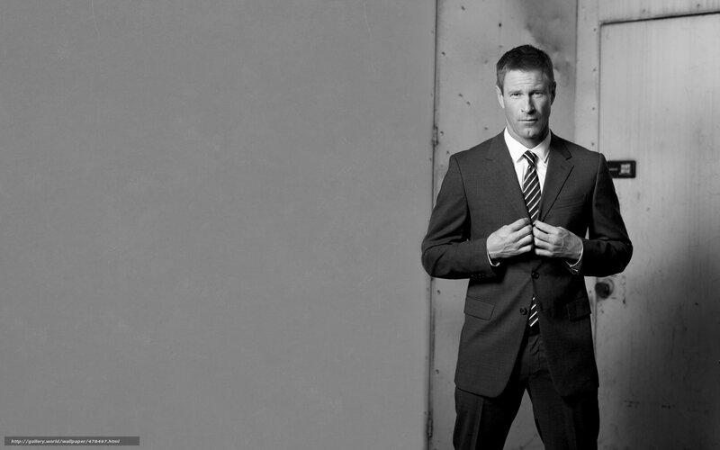man in a suit adjusting jacket