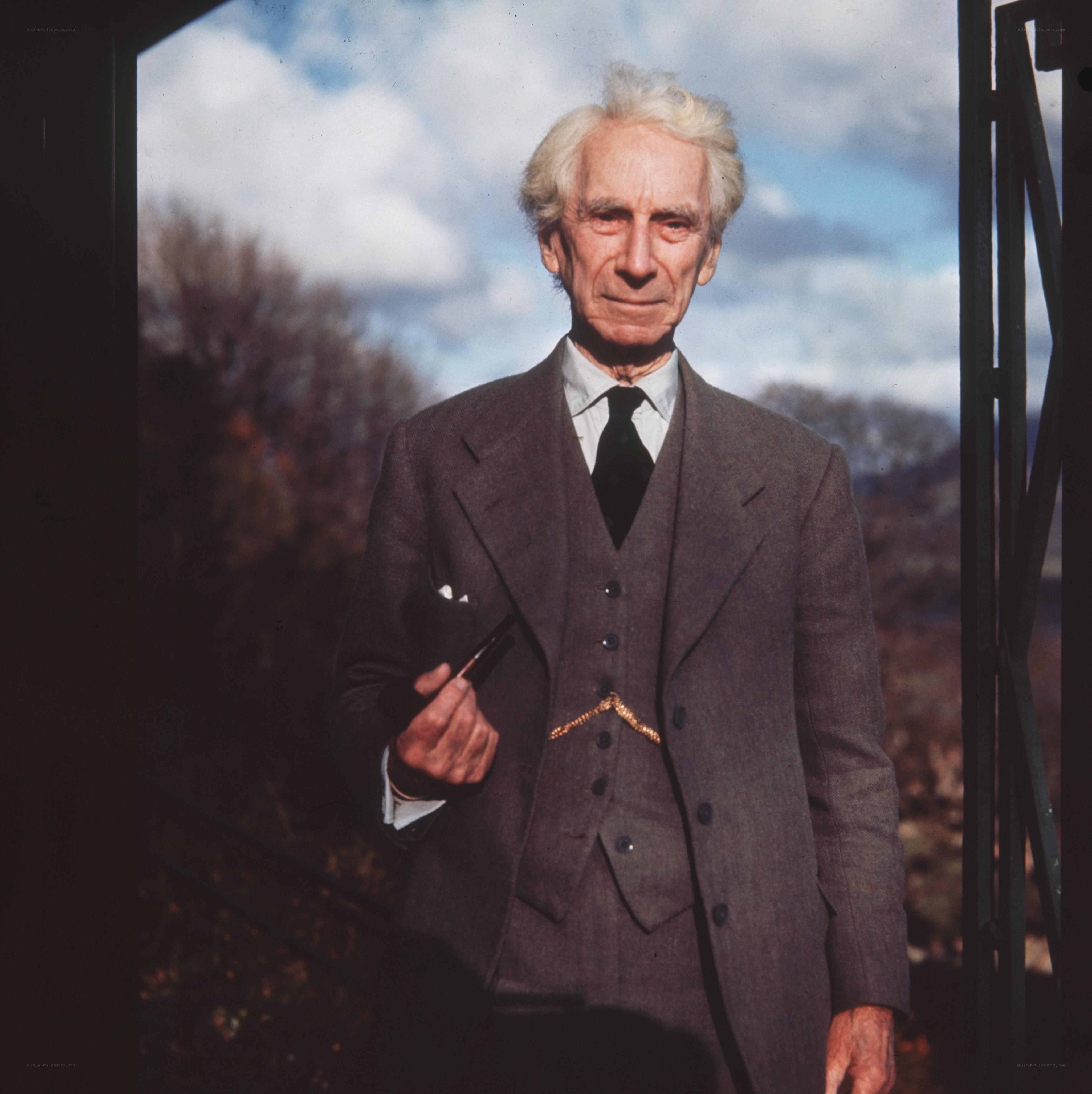 Man in a suit holding a pipe