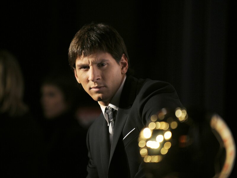 Man in a suit holding an award