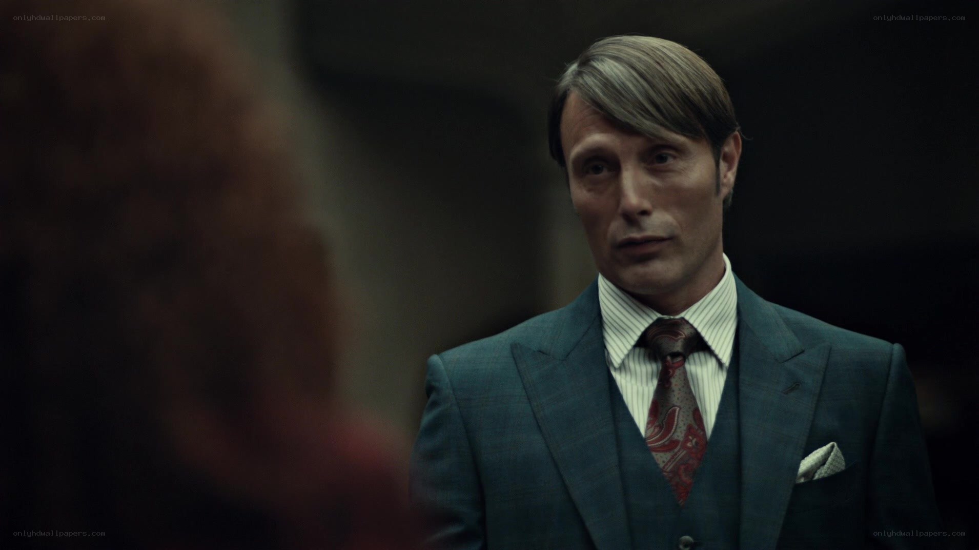 man in a suit looking at someone
