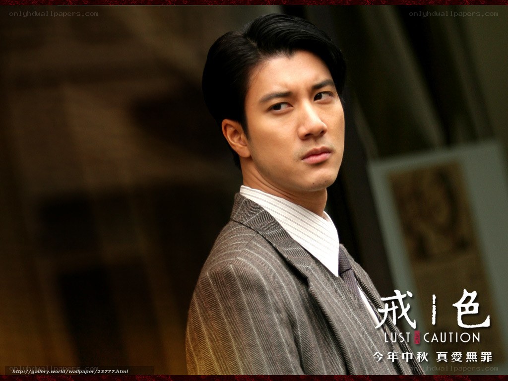 Man in a suit looking over shoulder