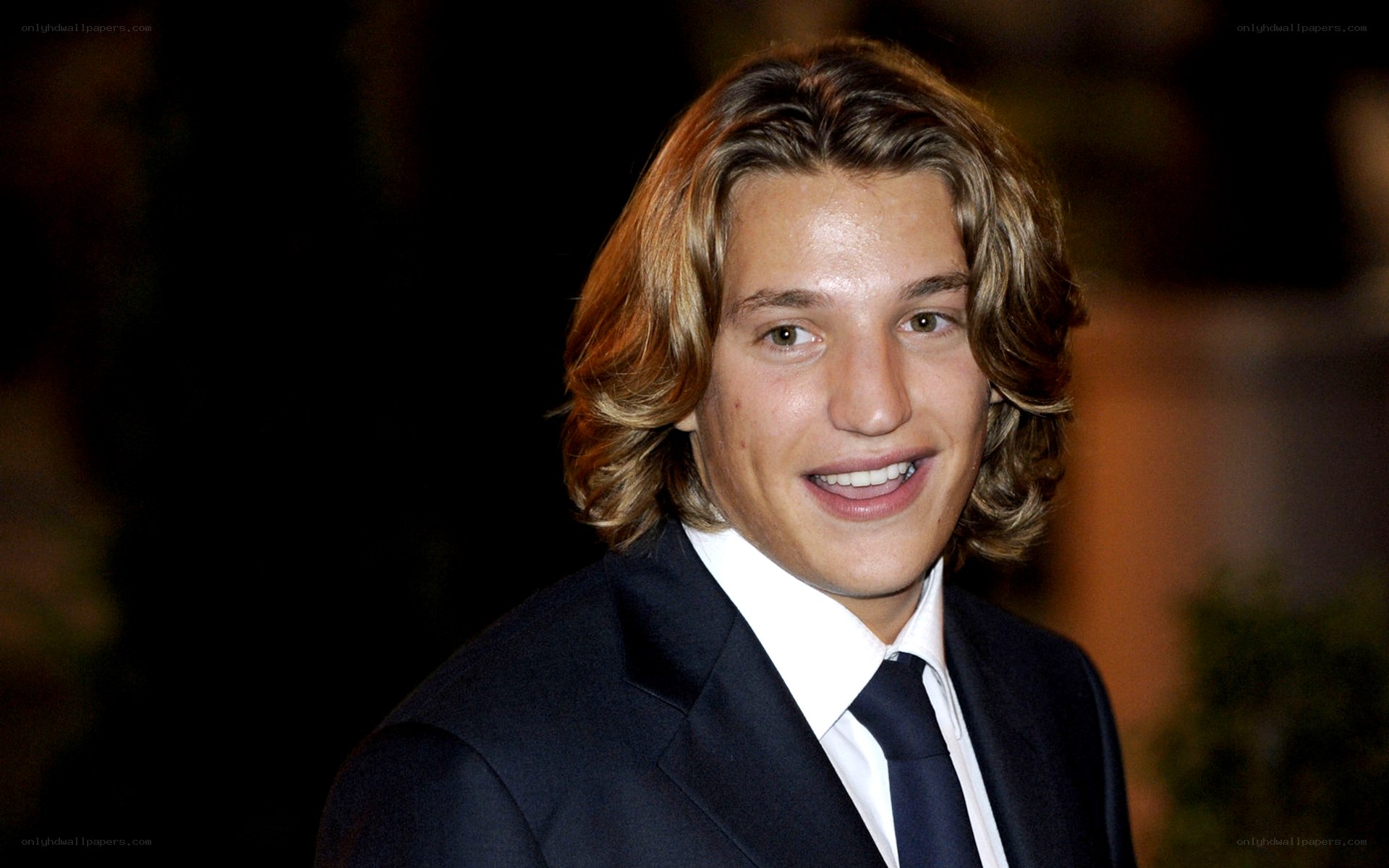 man in a suit smiling