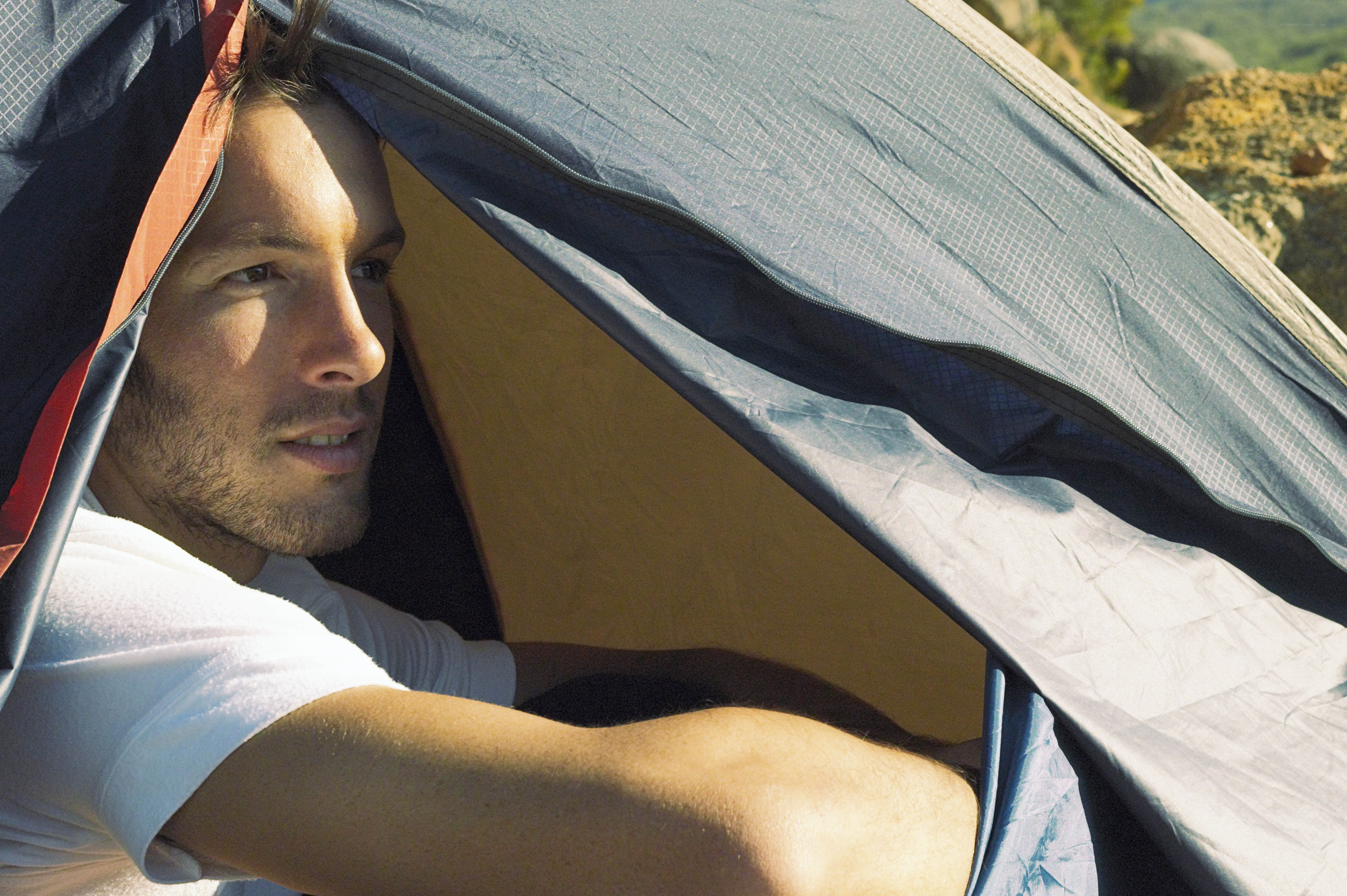 Man in a tent at campsite