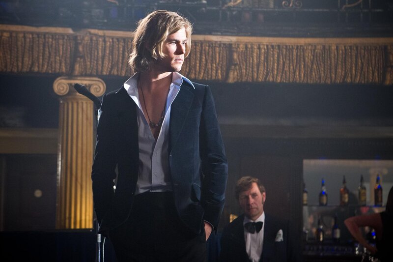 Man in a velvet suit on stage