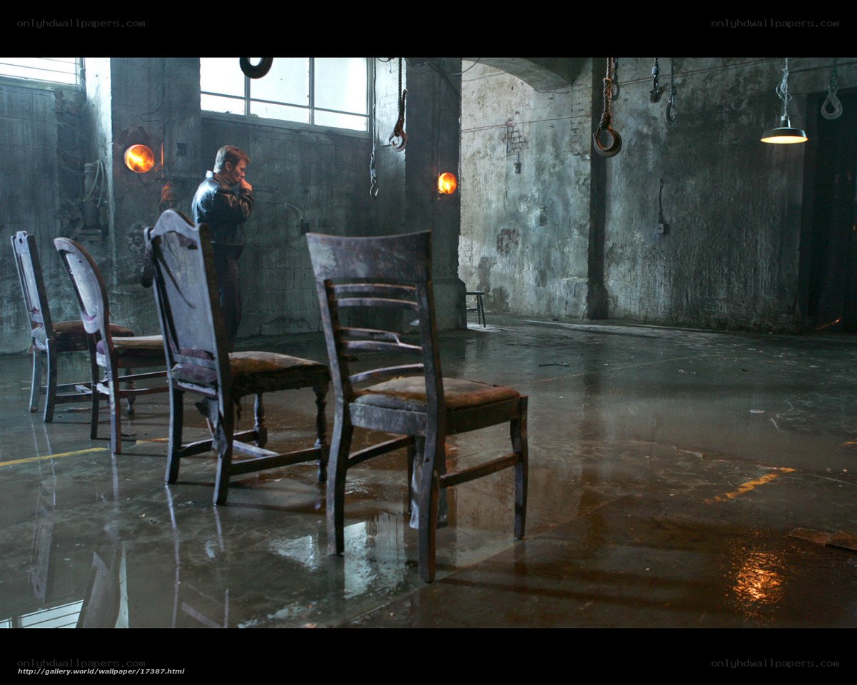 man in abandoned room with chairs