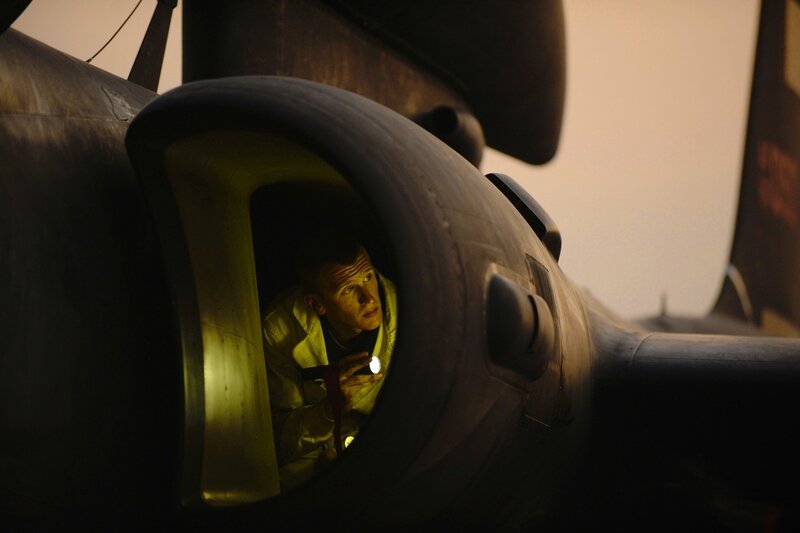 Man in aircraft cockpit at dusk