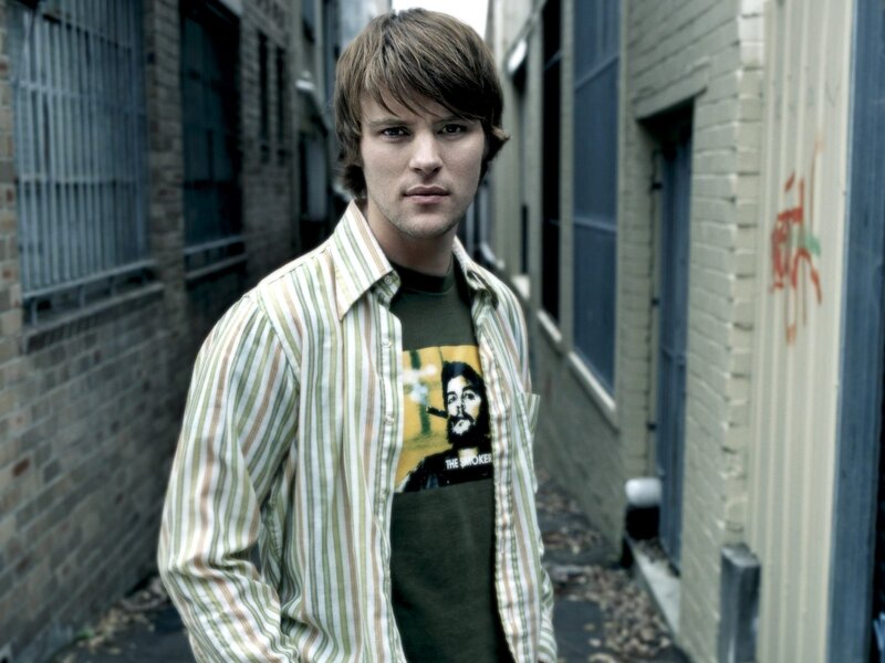 man in alley wearing striped shirt
