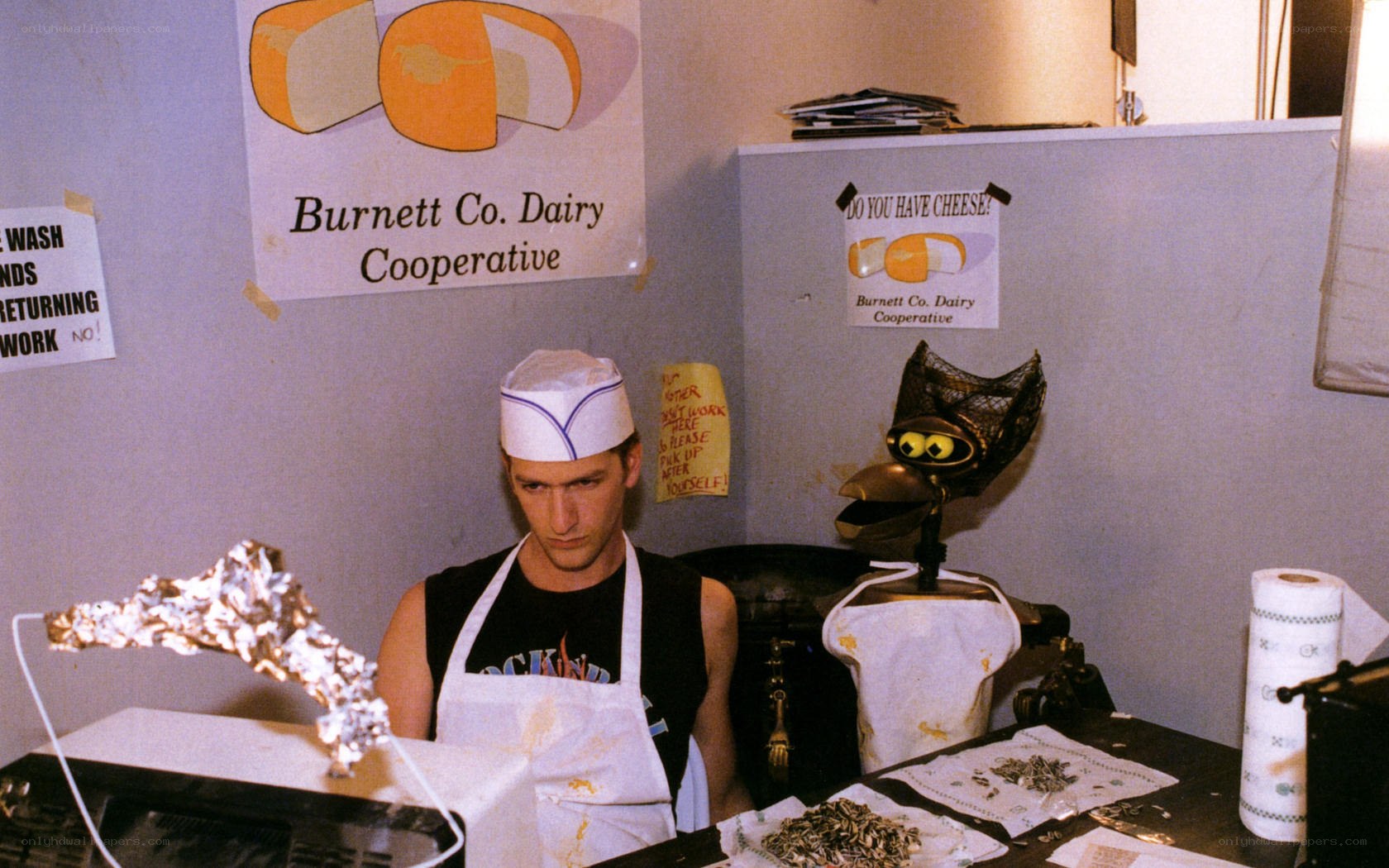 Man in apron at cheese counter