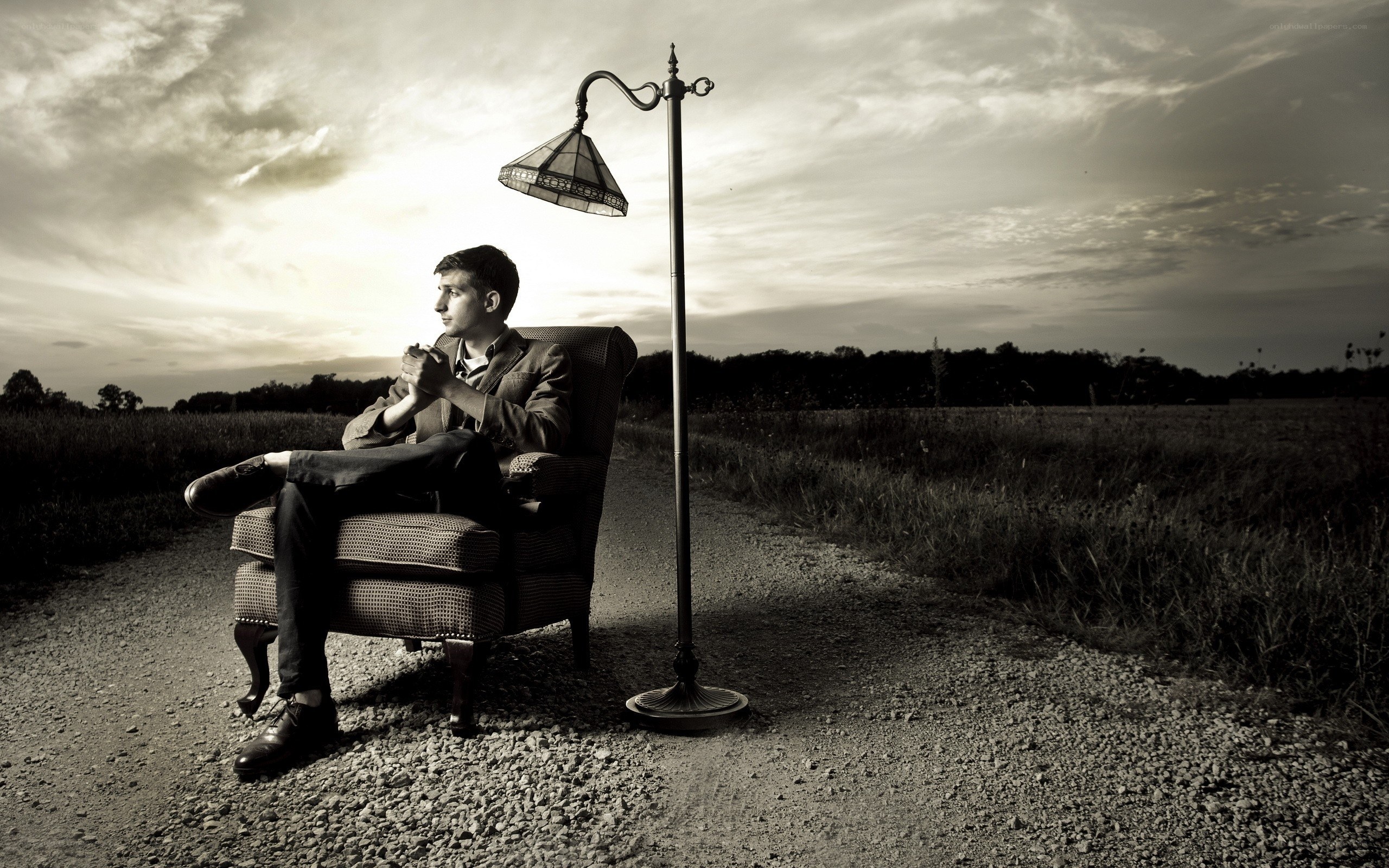 Man in armchair on dirt path