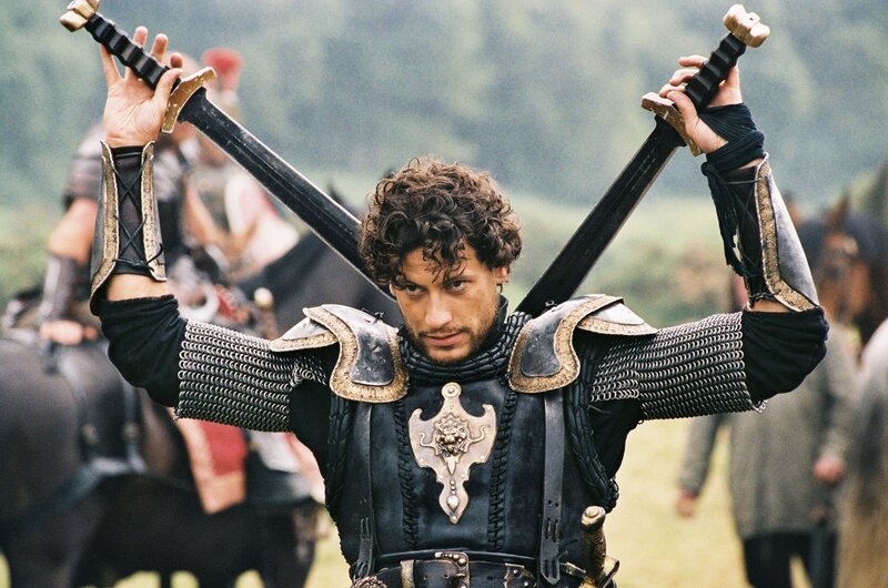 Man in Armor Holding Swords