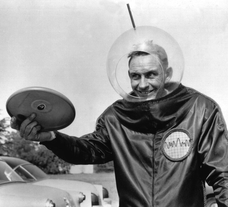 Man in astronaut suit with flying saucer
