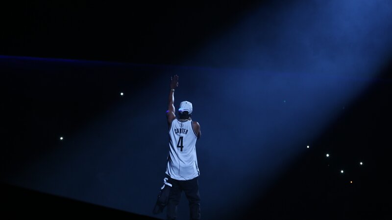 Man in basketball jersey on stage