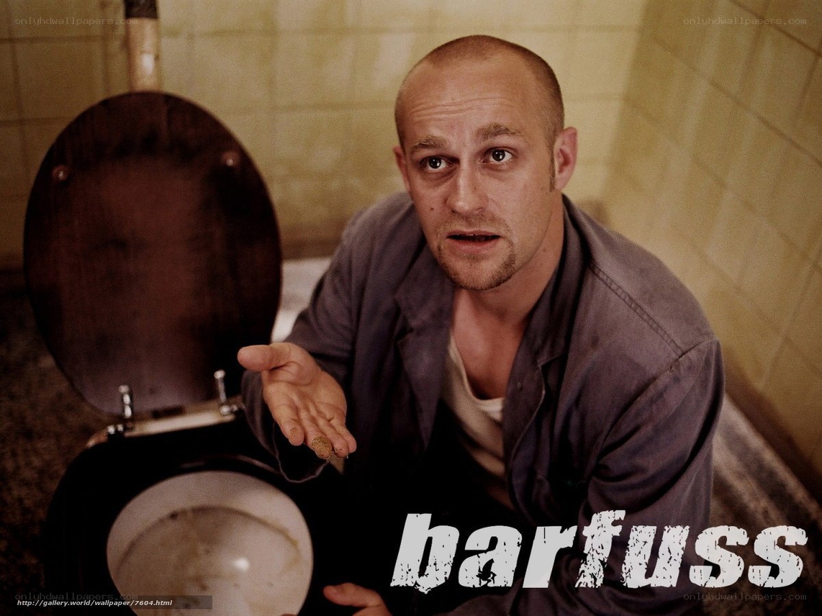 man in bathroom holding coin