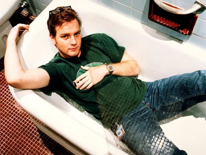 man in bathtub wearing green shirt