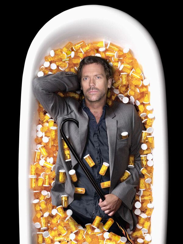 Man in bathtub with pills