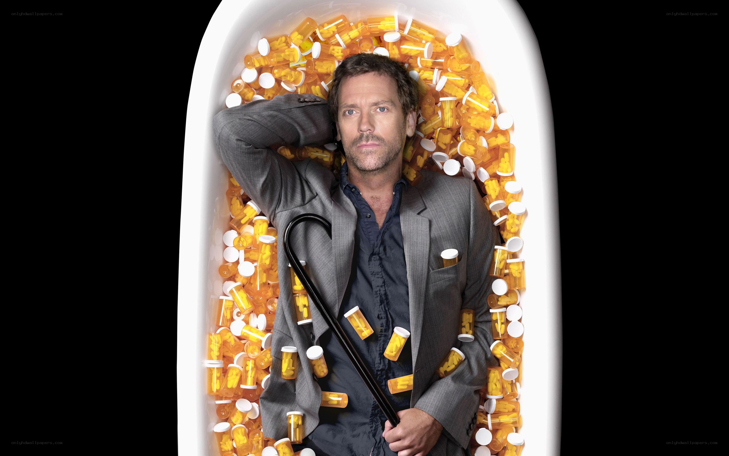 Man in bathtub with pills