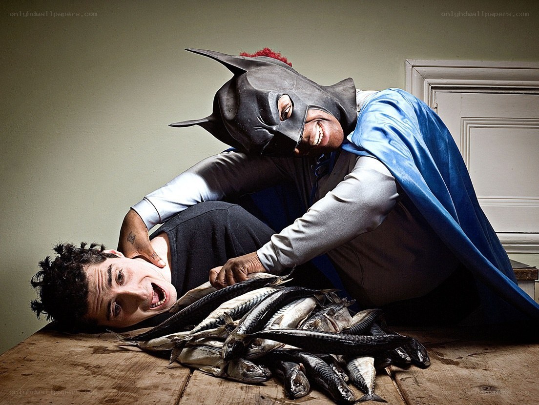 Man in Batman costume with fish