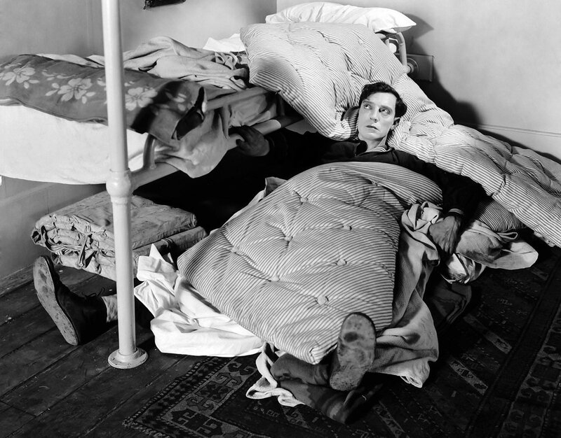 Man in bed under blankets