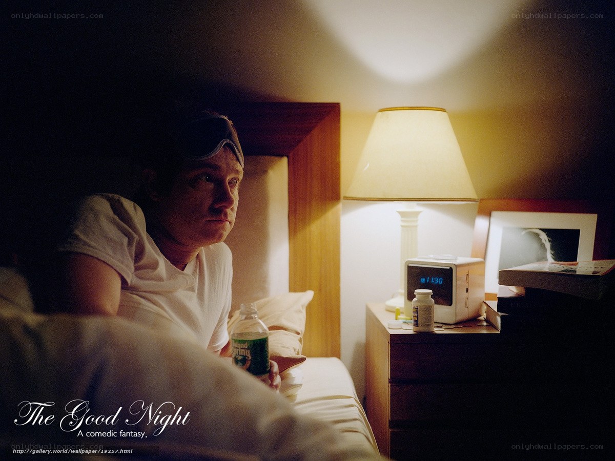 Man in bed with sleep mask