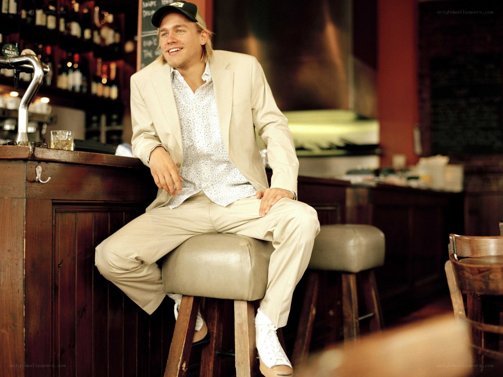 Man in beige suit at bar