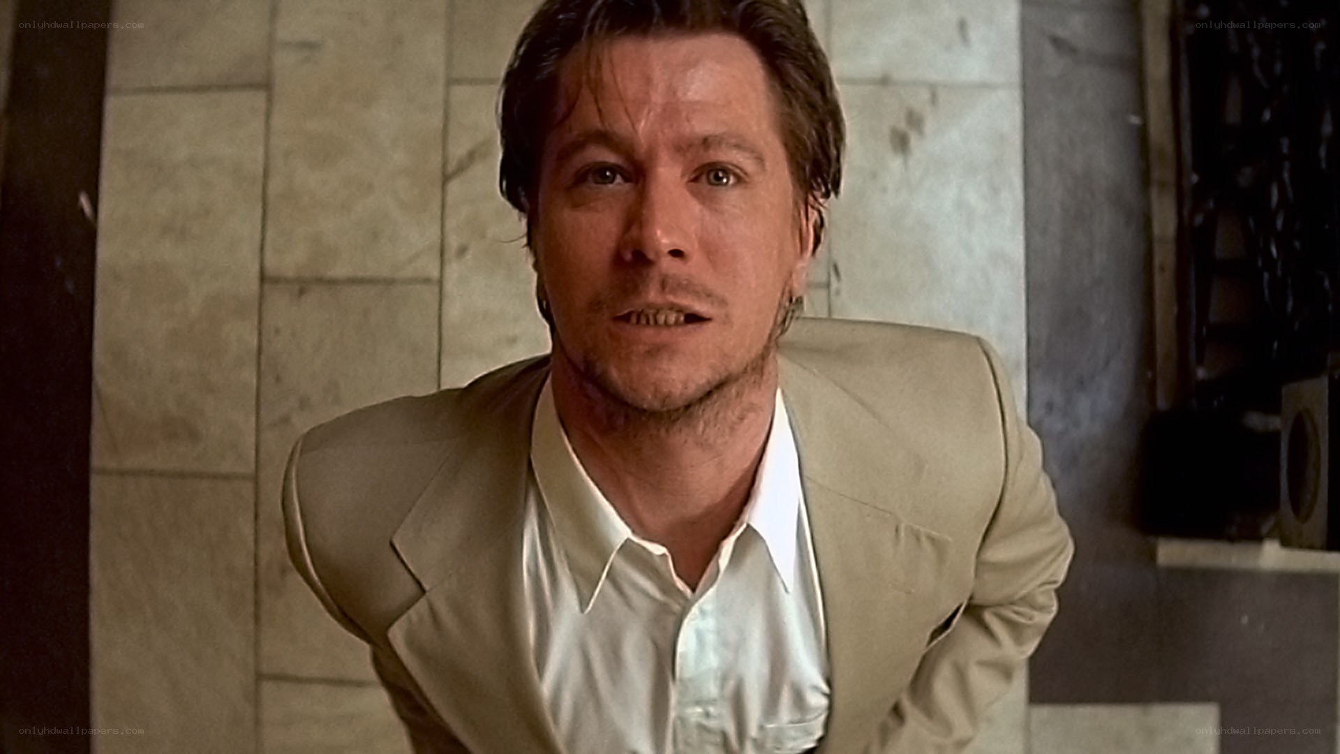 man in beige suit looking up
