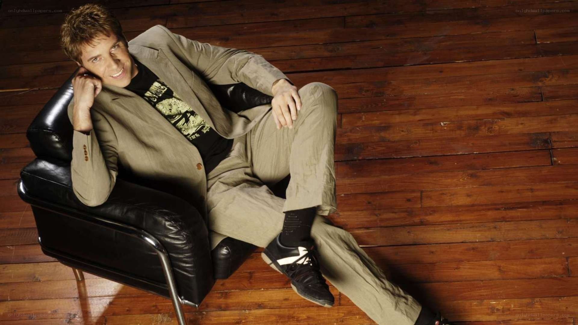man in beige suit sitting