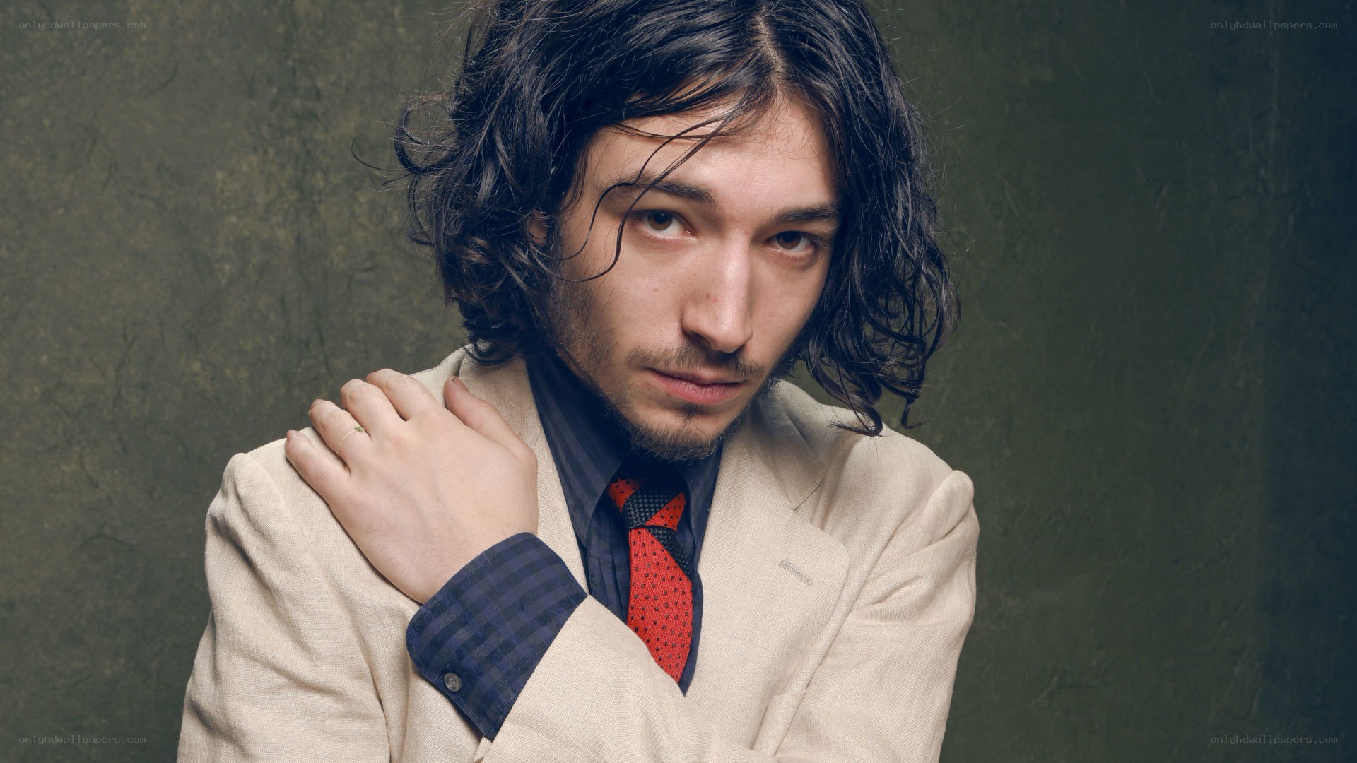 man in beige suit with red tie