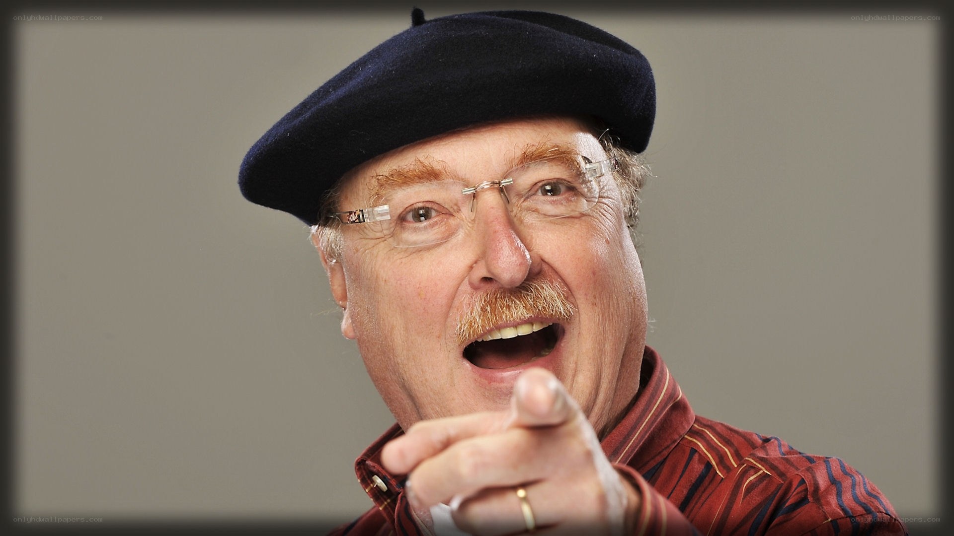 man in beret pointing at camera