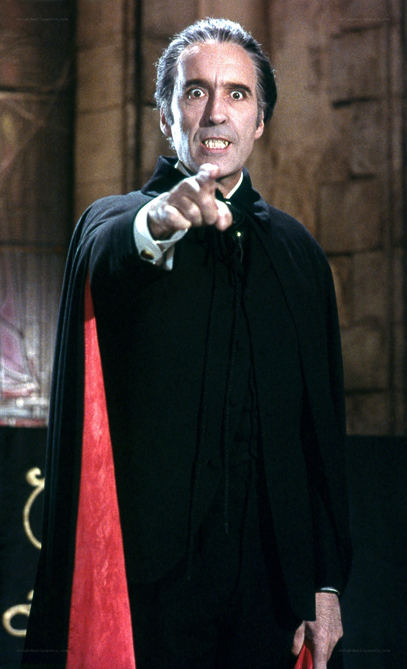 Man in black cloak pointing